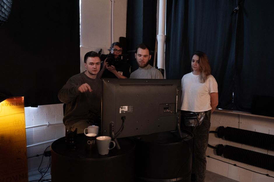 A group collaborates on a video production project in a studio setting.